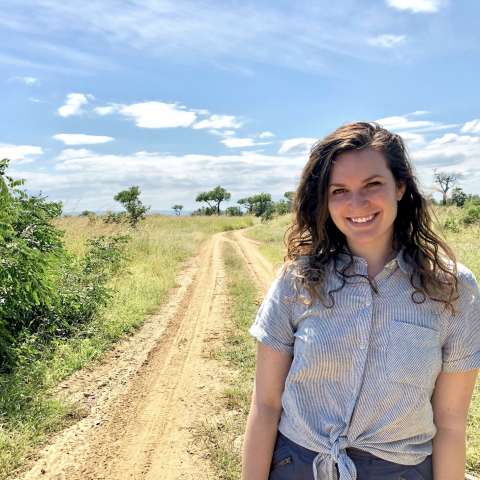NHC PGH member Emily smiling on a sunny day in the countryside