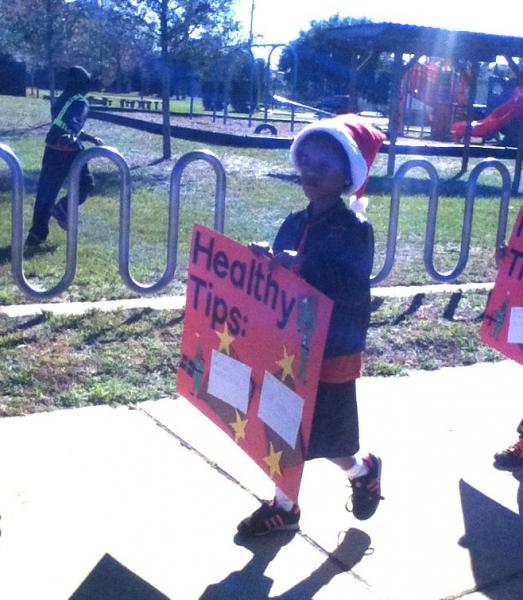 Tiger Academy student carries sign with Healthy Tips