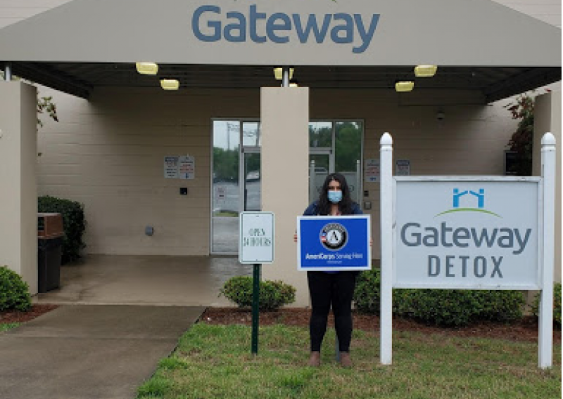 NHC member Roya stands outside the entrance to the Gateway Detox Building.