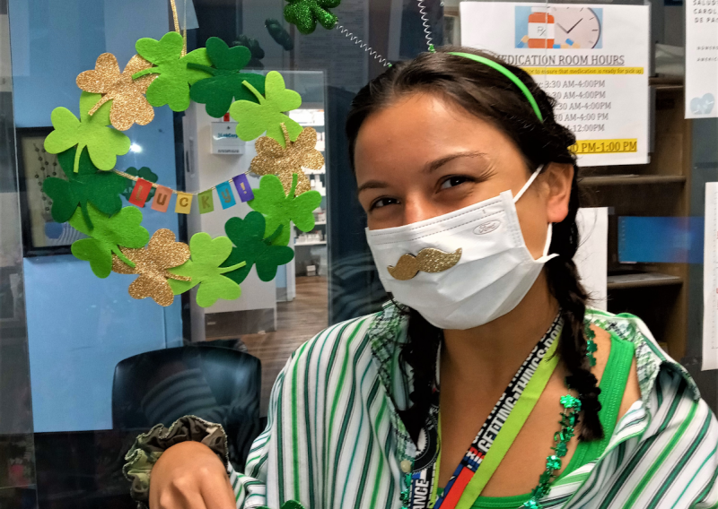 carol wearing a shamrock headband and surrounded by other st patricks day decor