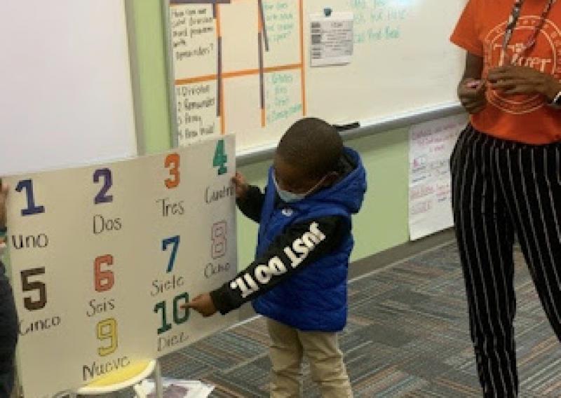 Kimberly teaching a Tiger Academy student numbers in Spanish.