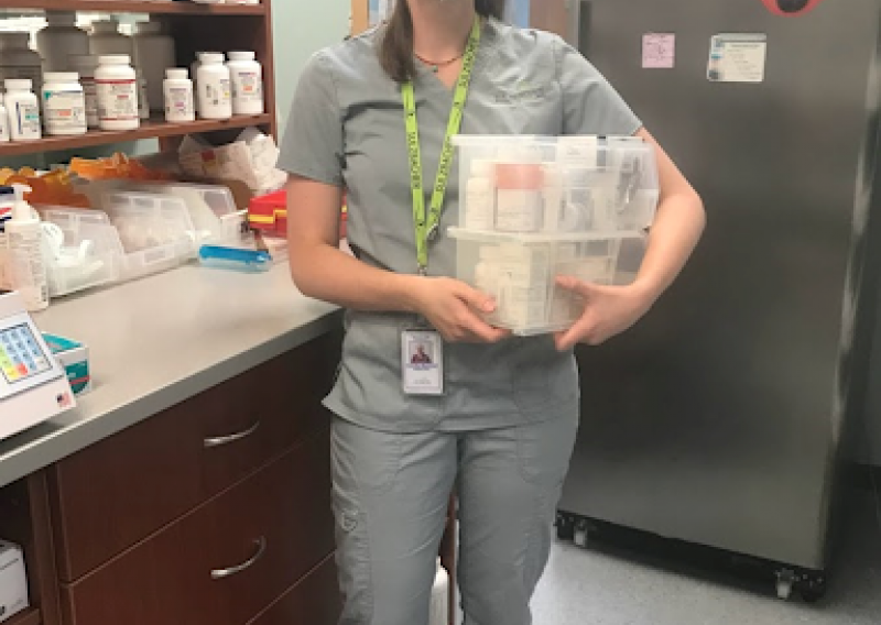 Camille sorting through patient medications at the Sulzbacher pharmacy.