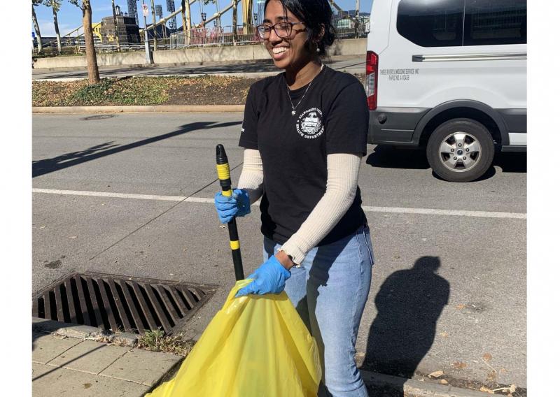 Anisha participates in a litter cleanup.