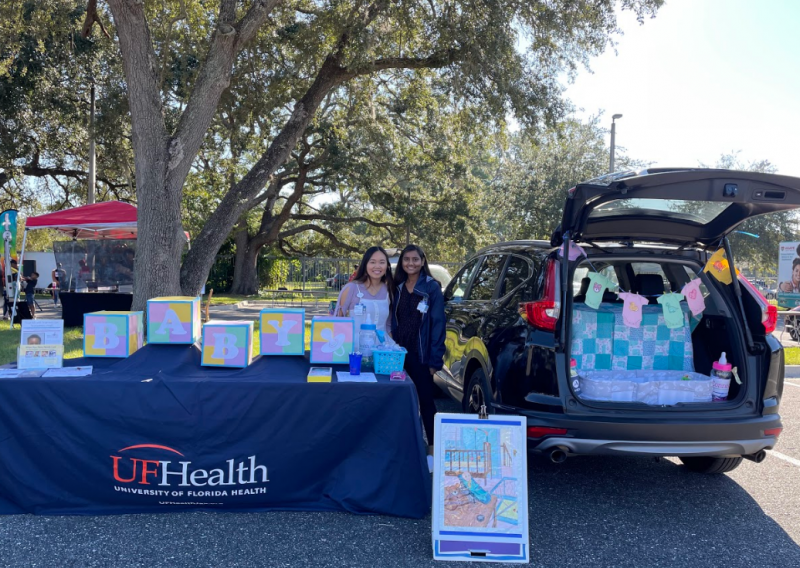 Pictured is Binta Patel and Katelyn Griffen, current NHC FL members, tabling for their host site. 