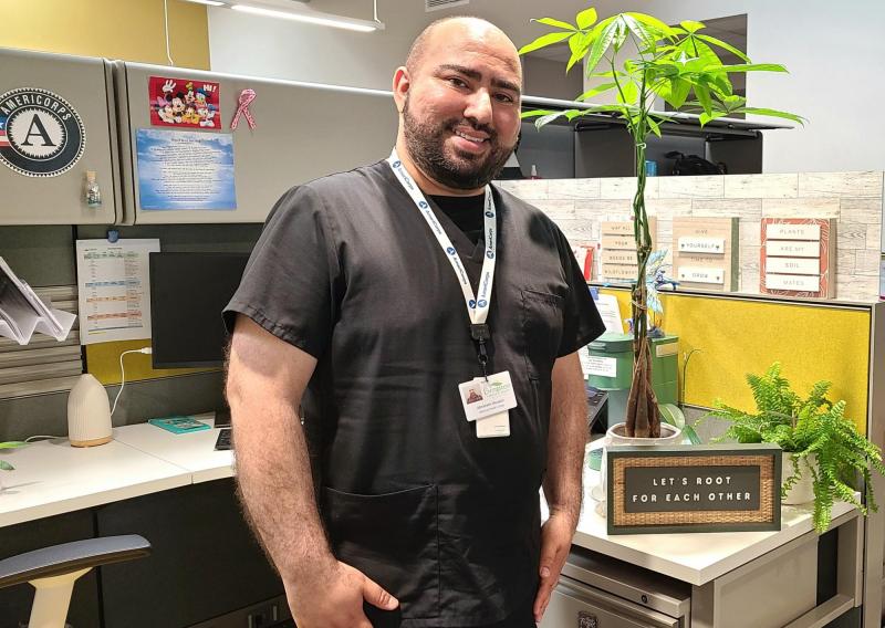 Abraham Housini in his cubicle with his plants