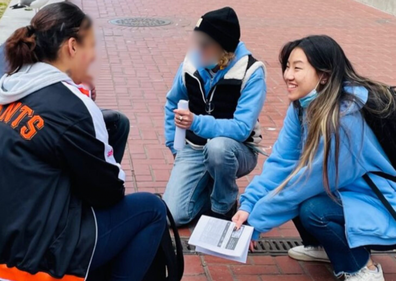 Vivian (right) and another outreach worker (middle) speak with a patient (left). 