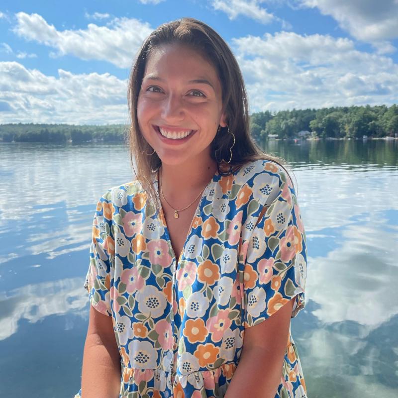 Penelope Velasco smiling for the camera with a lake in the background.