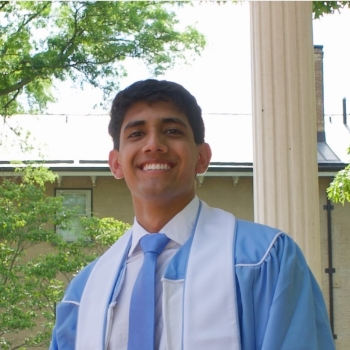 Dev in light blue graduation gown
