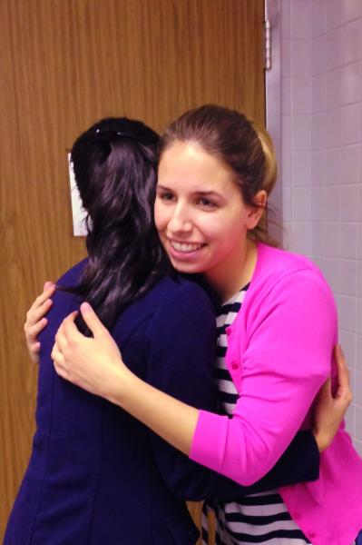 NFHC AmeriCorps member, Maddy, hugging a client.