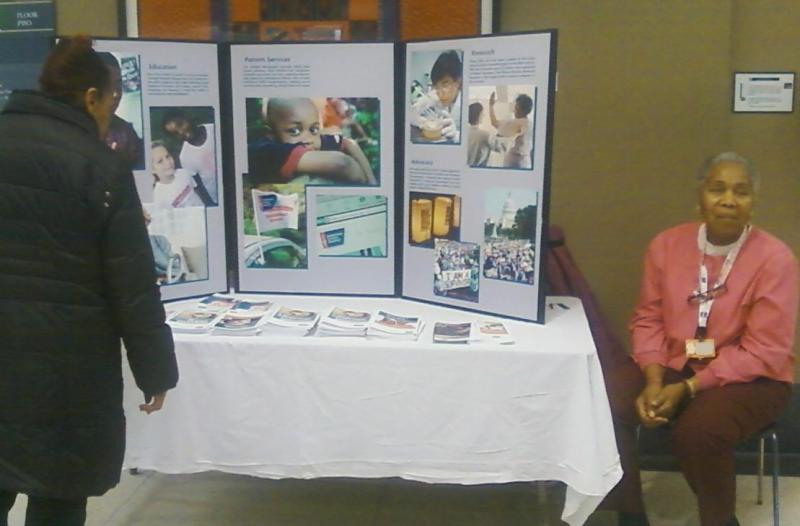 An American Cancer Society volunteer, right, helps interested patrons find information on cancer prevention, smoking cessation, and healthy living at John H. Stroger Jr. Hospital of Cook County in Chicago, IL for Lung Cancer Awareness Month.