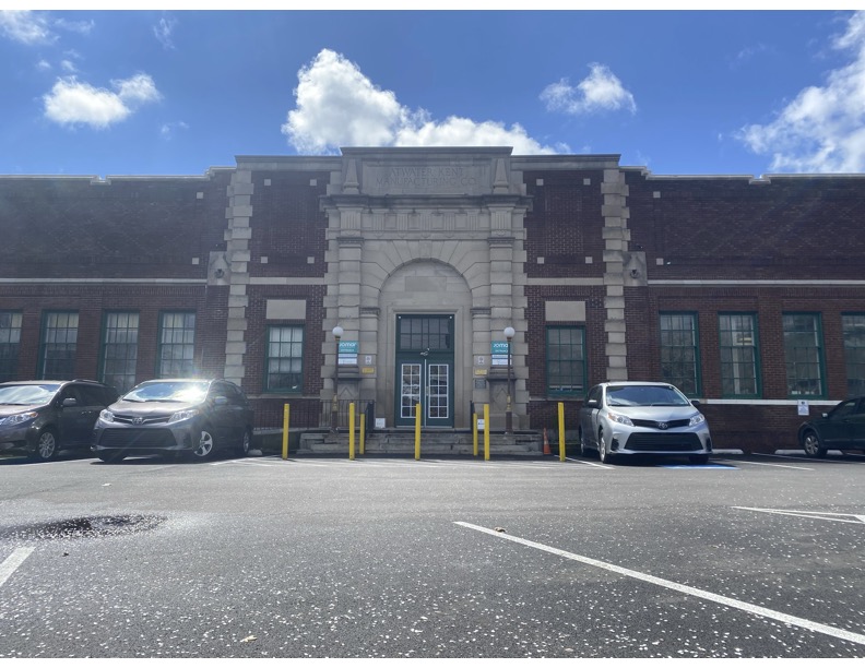 The outside of Abbottsford Falls Health Center with four cars in the parking lots