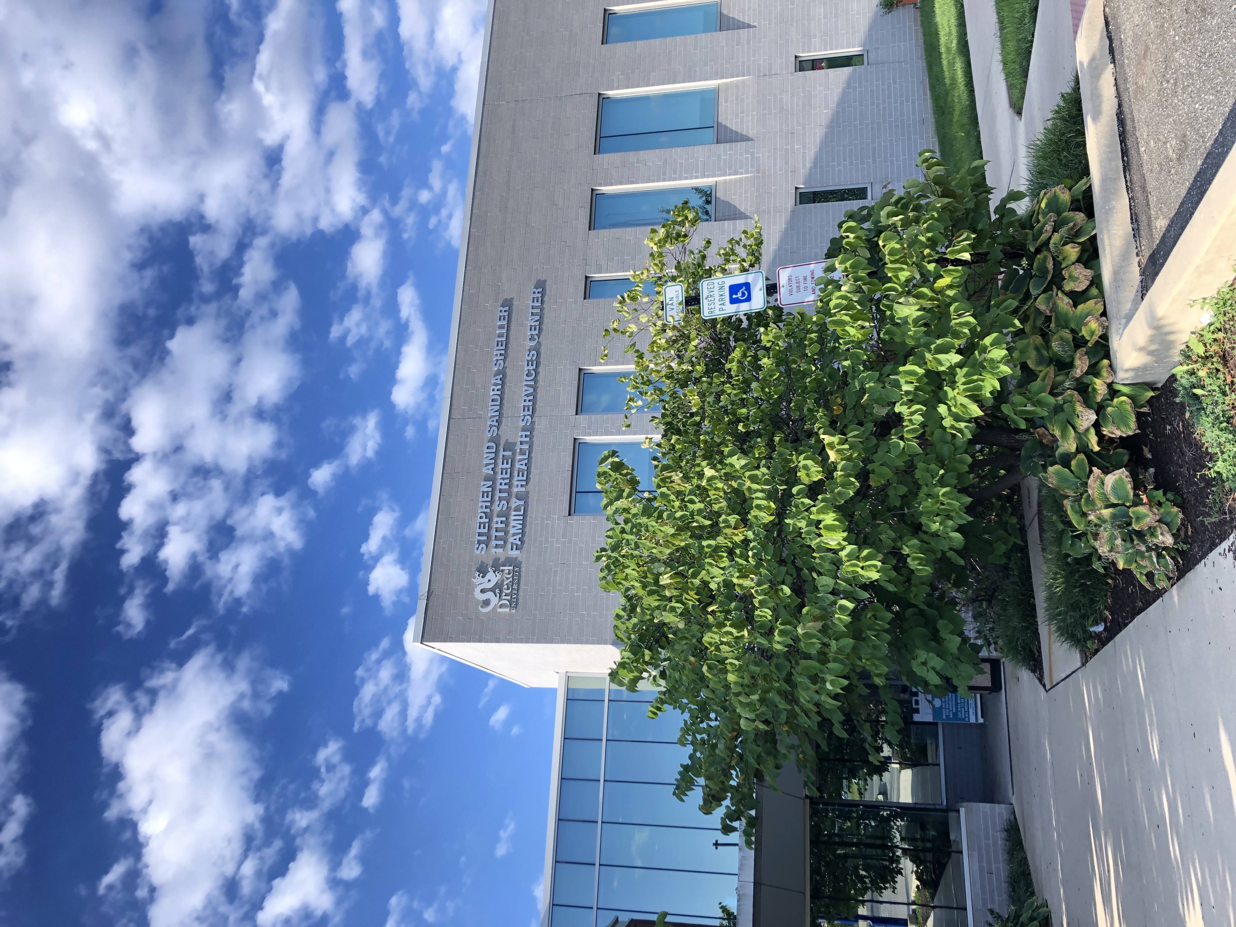 The outside of Stephen and Sandra Sheller 11th Street Family Health Services on a sunny day