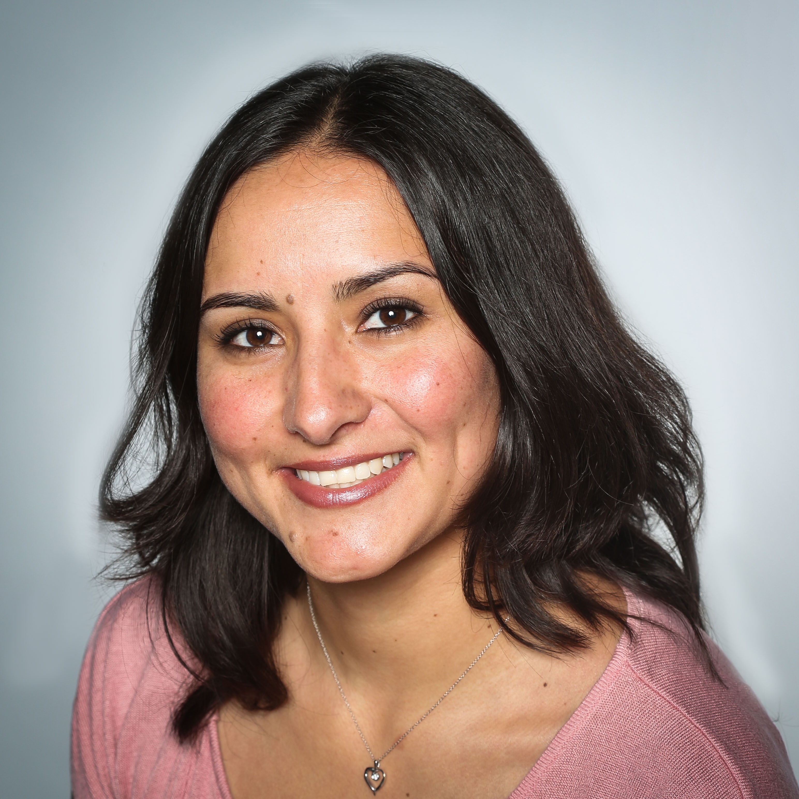 A headshot of Lilibeth Morales facing the camera and smiling. Lilibeth is positioned with a white-gray background.