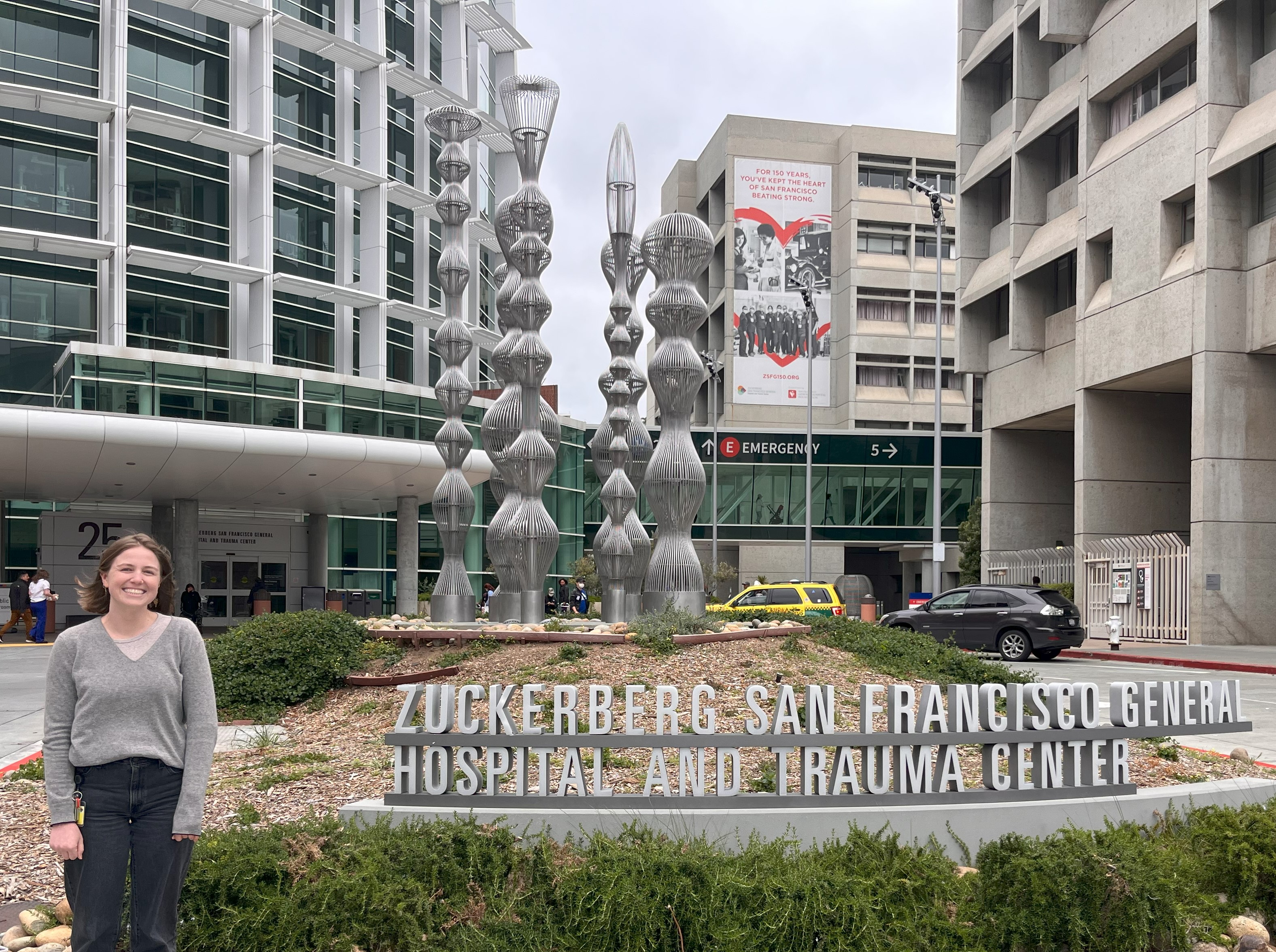 Morgan is standing next to a sign that reads Zuckerberg San Francisco General Hospital and Trauma Center.