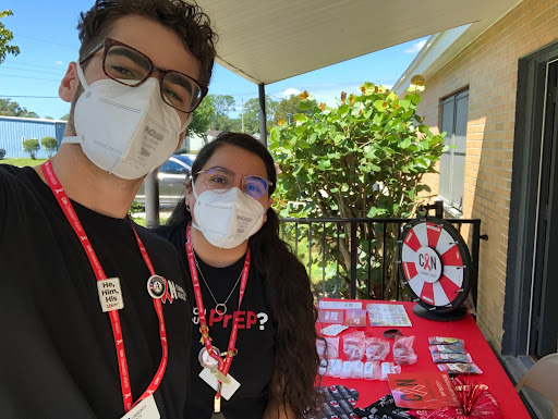 "Younis (left) and Alexia Cepeda (right) are pictured at a community outreach event in Flagler County, providing HIV and Hepatitis C testing."