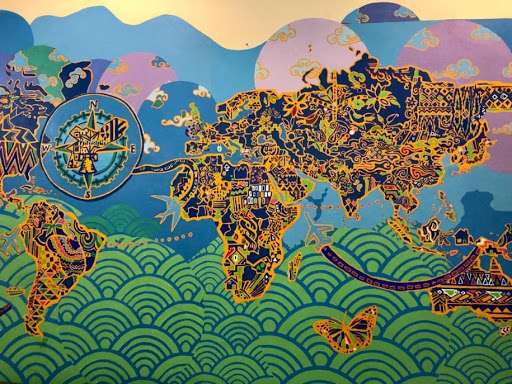 a colorful mural of the world painted on a wall