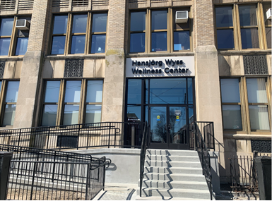 The Wyss Wellness Center exterior photo showing stairs and ramp to entrance